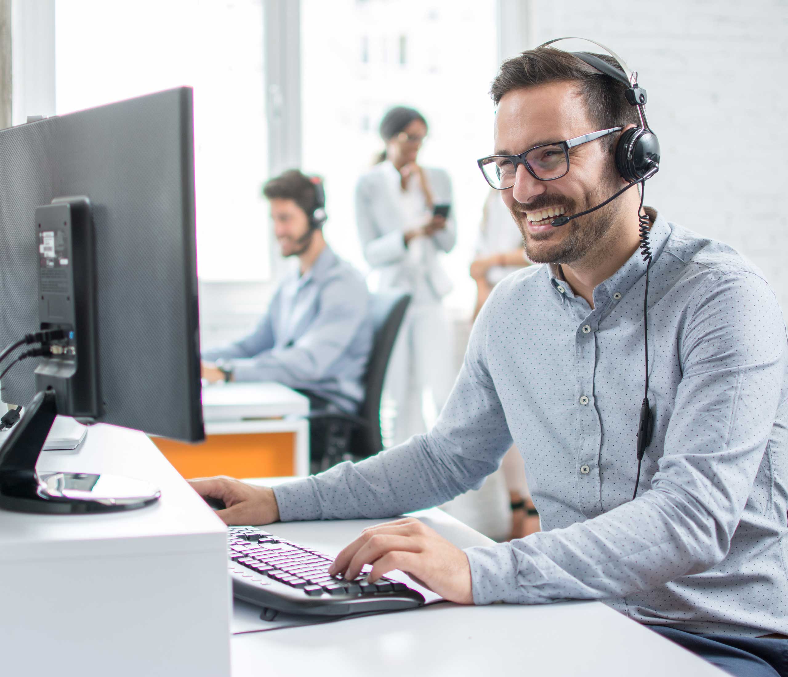 Man laughing while talking into headset