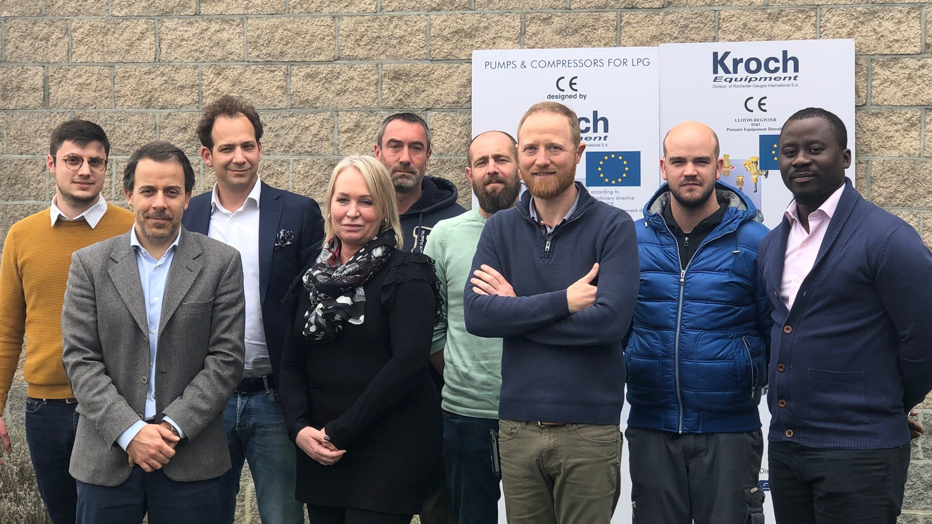The team of Kroch Equipment posing in front of a wall