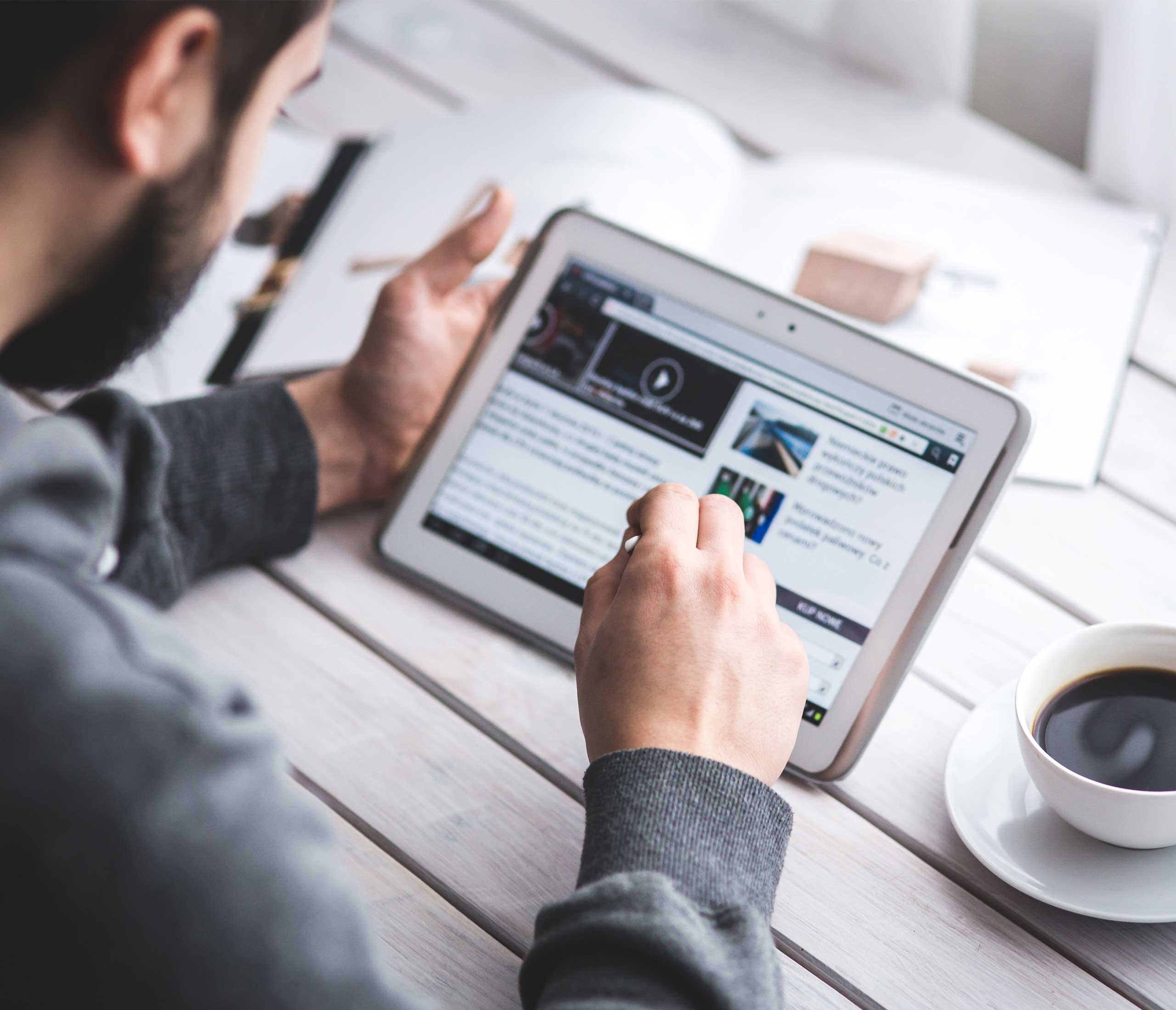 Man reading news on tablet device