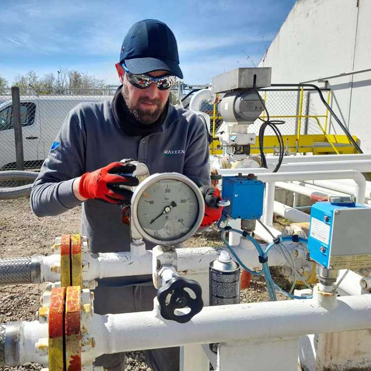 A photo of a MAKEEN Gas Equipment service man working on some pipes on site, doing preventative maintenance