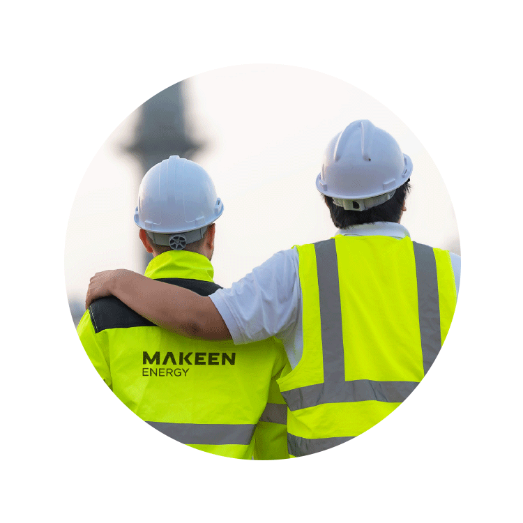 A photo of two men wearing hard hats and safety vests