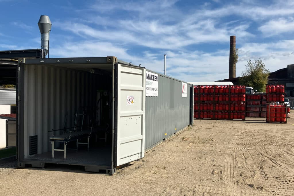 image of an open container and red LPG cylinders to right