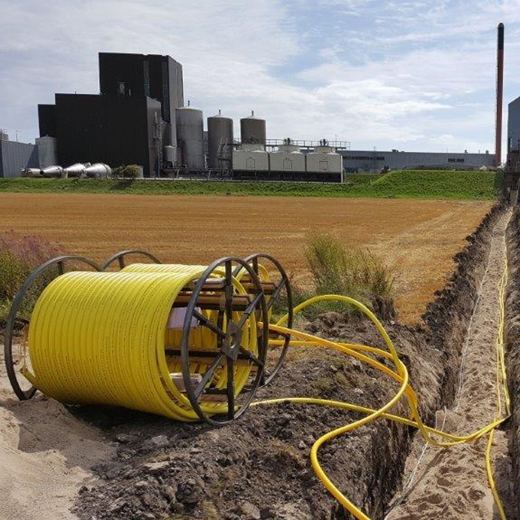 A photo of a dug-up field with Thermoflex hoses